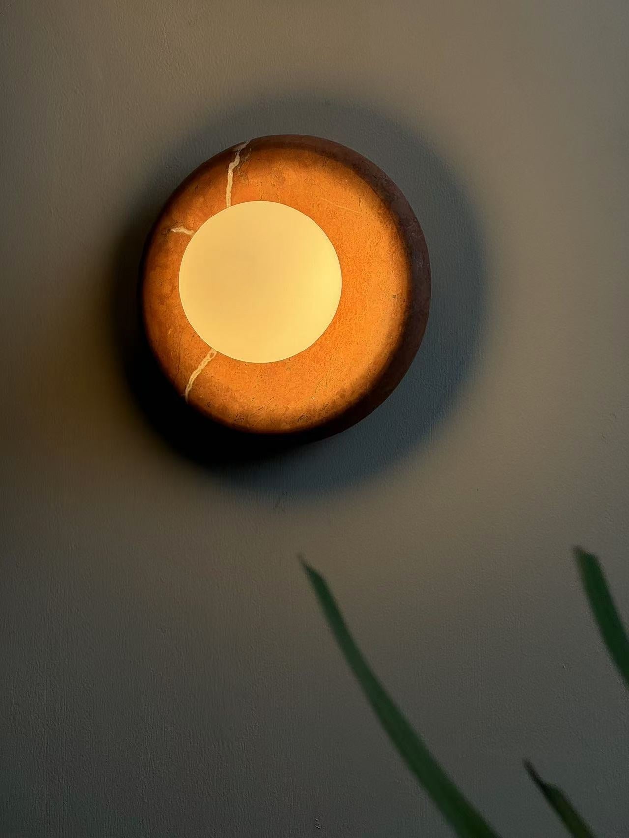Elegant Red Marble Wall Sconce with Soft Ambient Lighting for Cozy Atmosphere